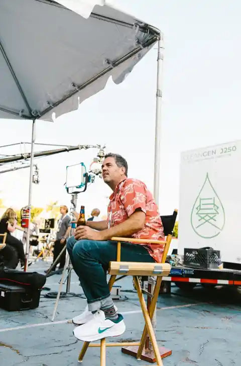 Trevor Wilkinson sitting on set beside a zero-emission CleanGen power generator